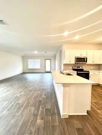 a open kitchen with cabinets stove and oven