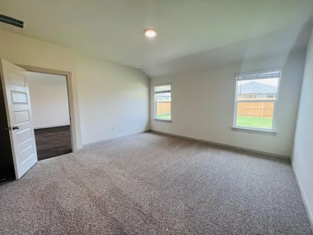 an empty room with windows and closet