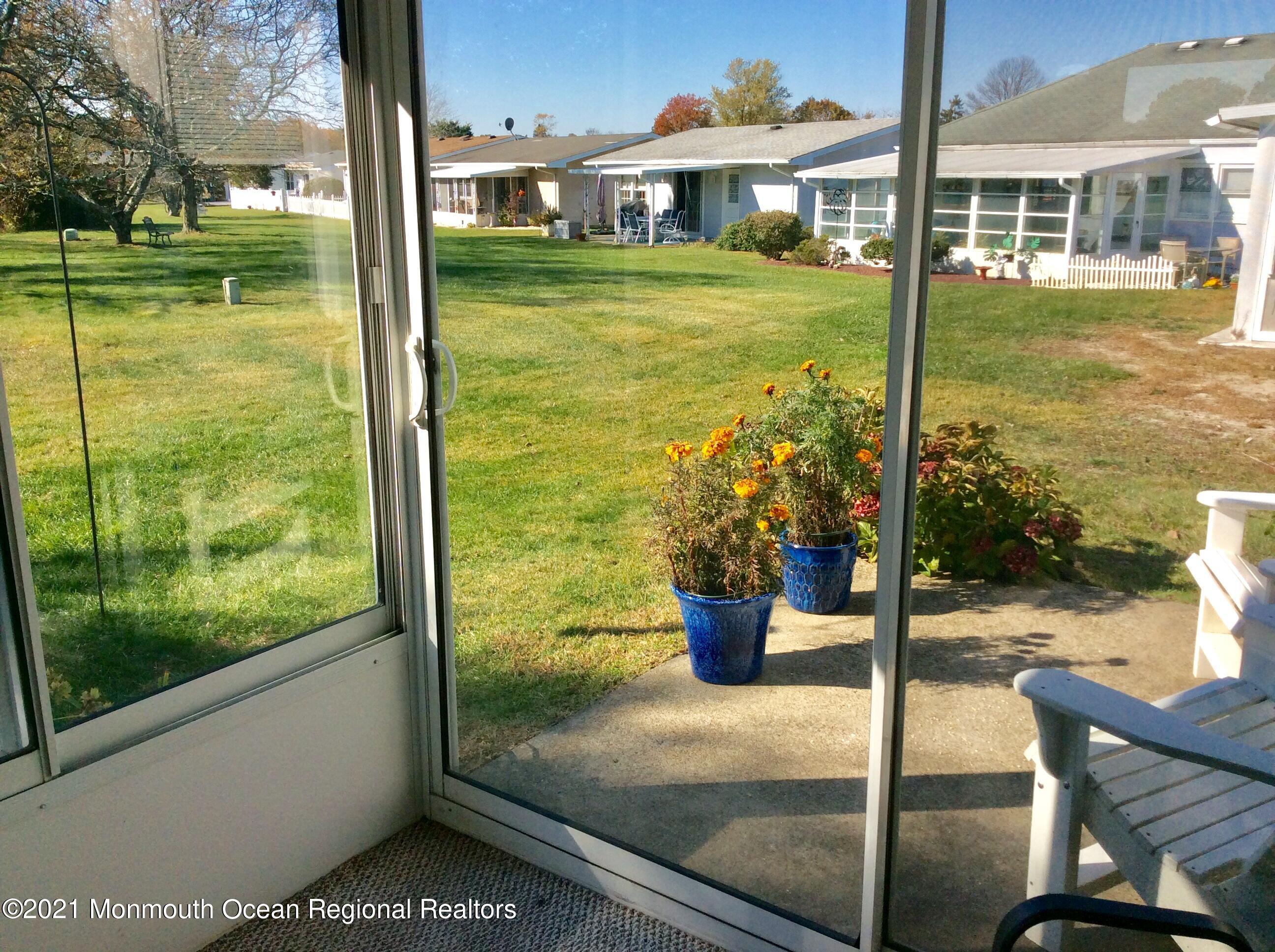 17 Phillips Road Brick, NJ 08724 - Photo 19 of 27 a view of a patio with a table chairs and a lake view