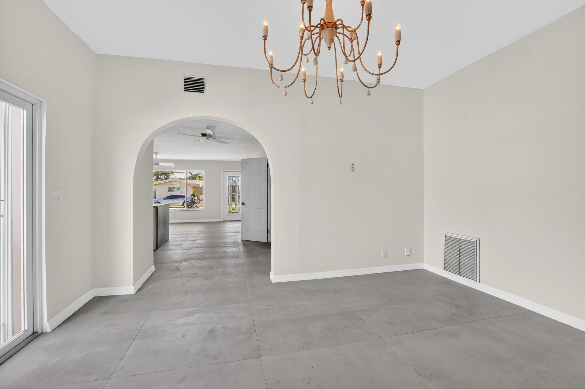 467 Northeast 31st Street Boca Raton, FL 33431 - Photo 7 of 18 a view of a livingroom with wooden floor and a chandelier