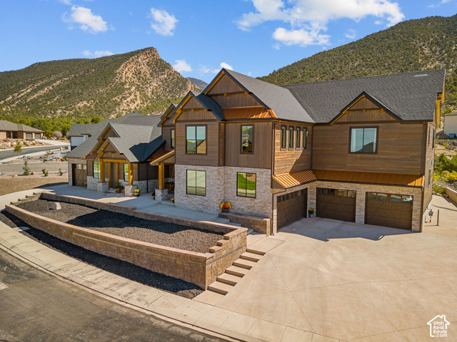 1192 East Ashdown Road Cedar City, UT 84721 - Photo 7 of 96 Crafted exterior featuring stone and wood-finish siding, a multi-gabled roofline, and a prominent front porch