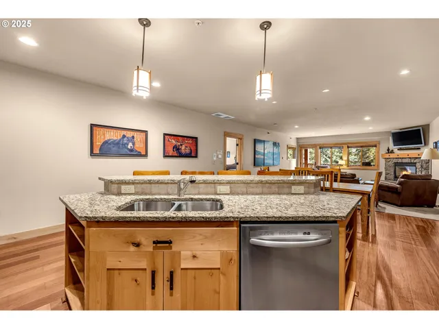 a kitchen with a counter space a sink and wooden floor