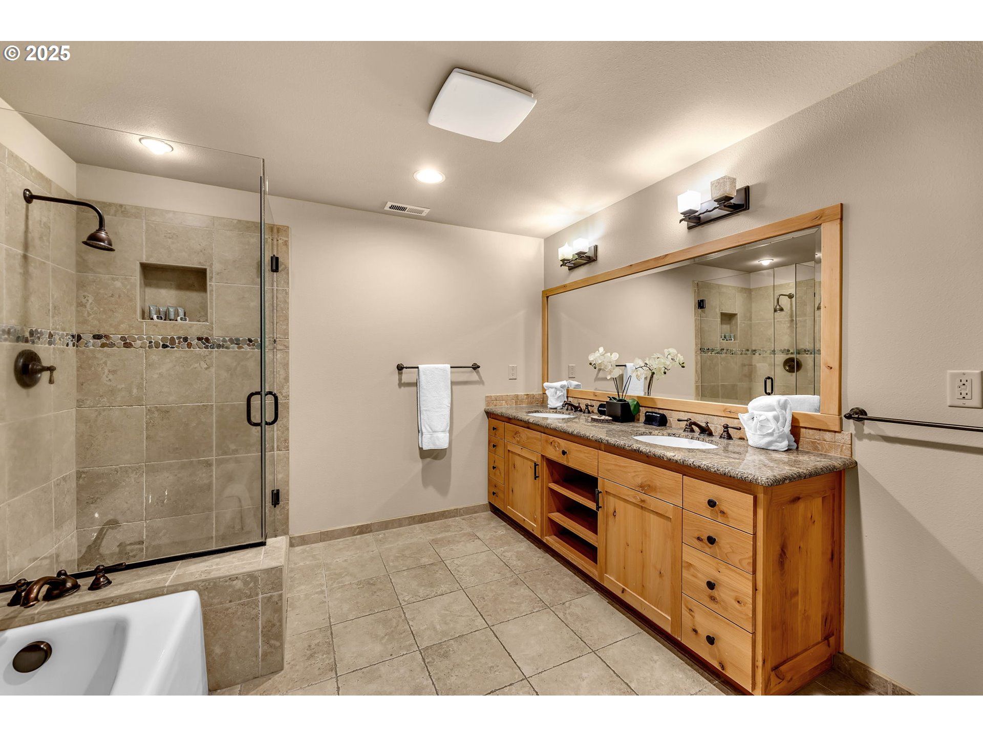31254 East Collins Lake Road, Unit 22 Government Camp, OR 97028 - Photo 26 of 44 a bathroom with a double vanity sink a toilet a mirror and shower