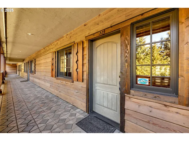 a view of hallway with wooden floor and windows