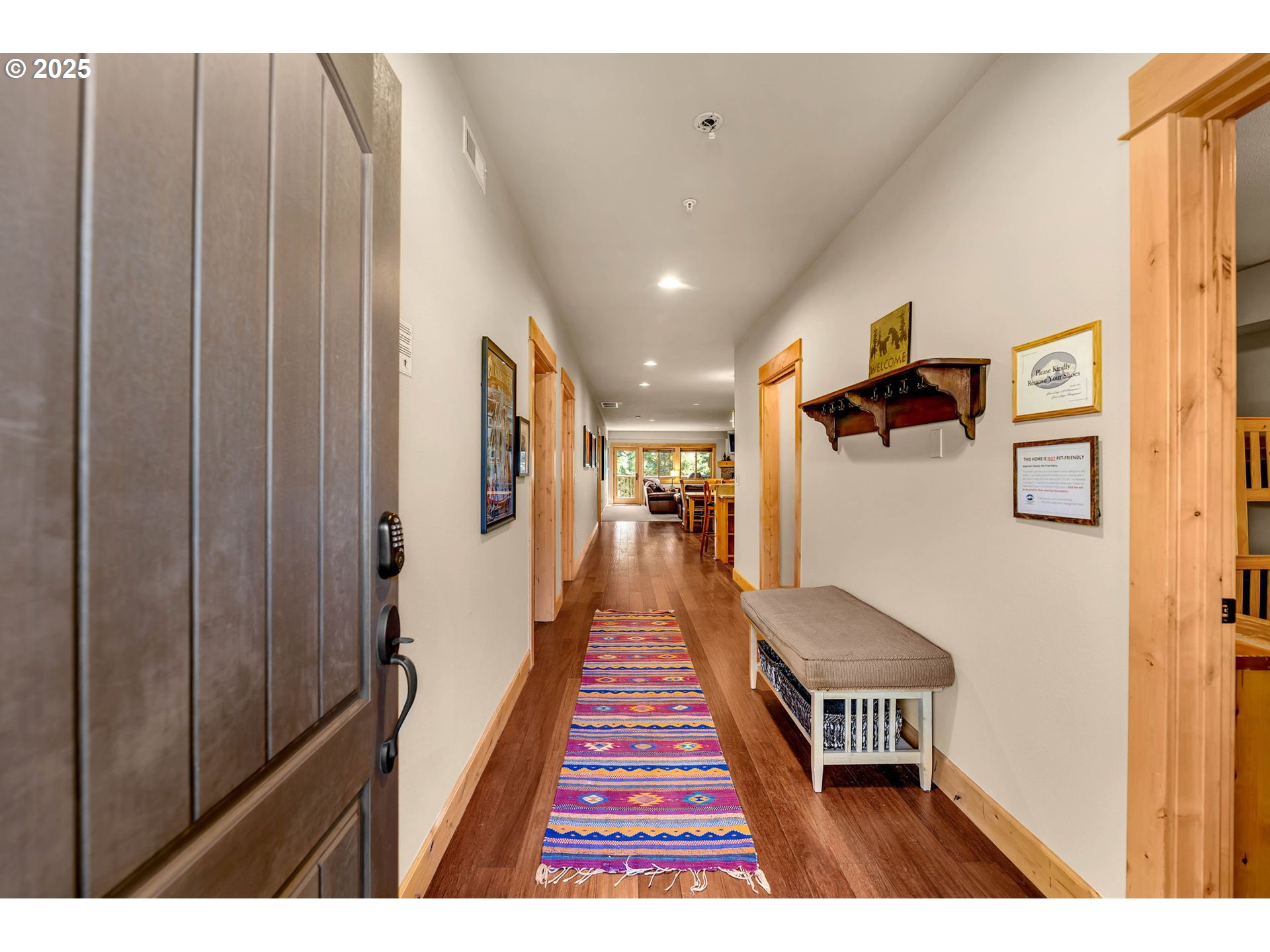 31254 East Collins Lake Road, Unit 22 Government Camp, OR 97028 - Photo 6 of 44 a hallway with a large mirror and wooden floor