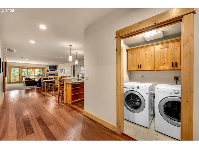 a view of a kitchen with furniture and wooden floor