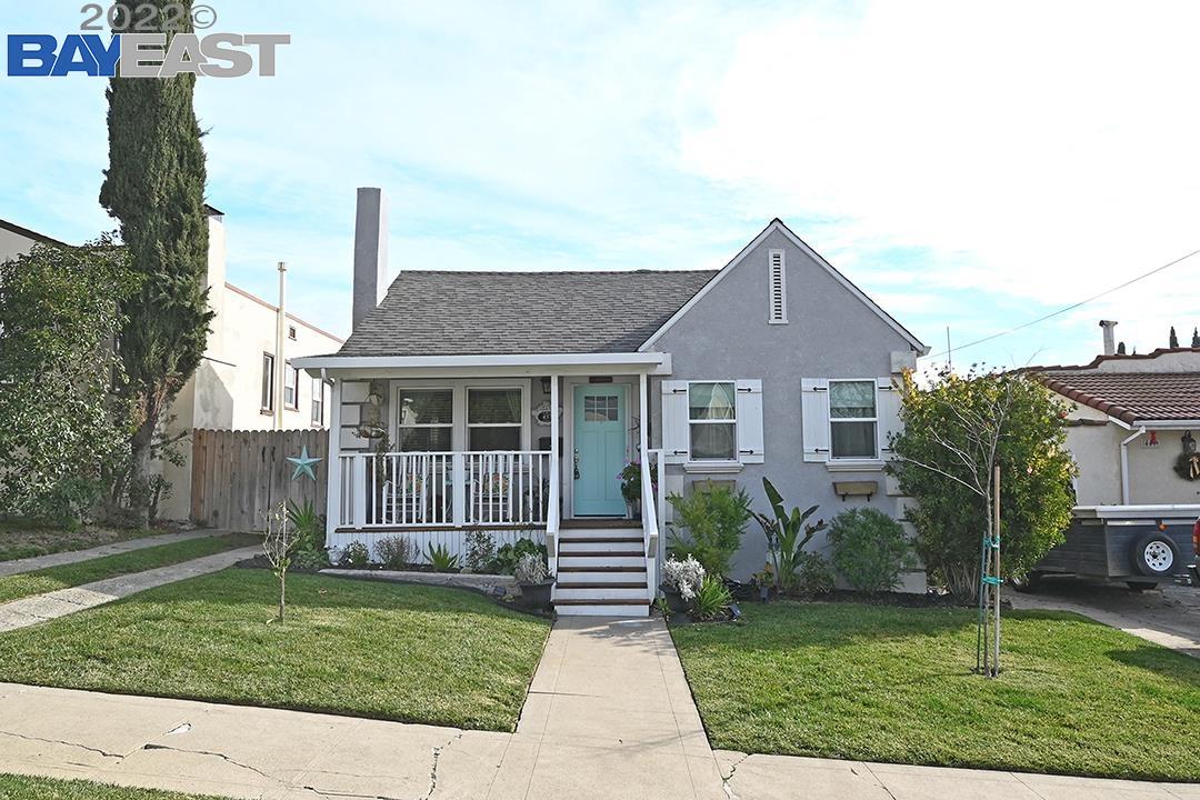 a front view of a house with a garden and yard