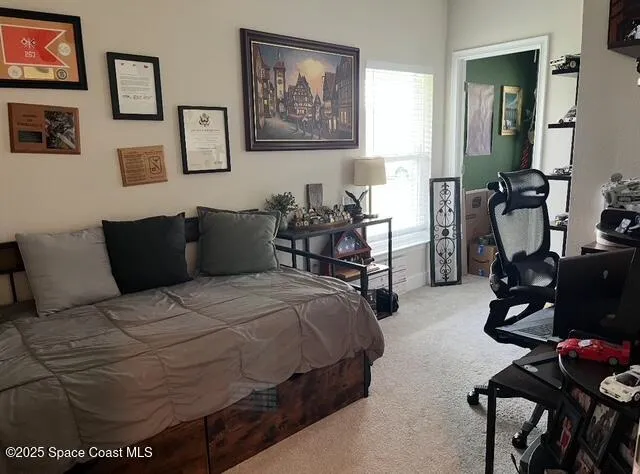 a bedroom with bed and furniture