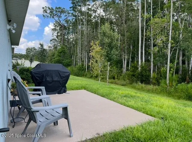 a view of a backyard with furniture