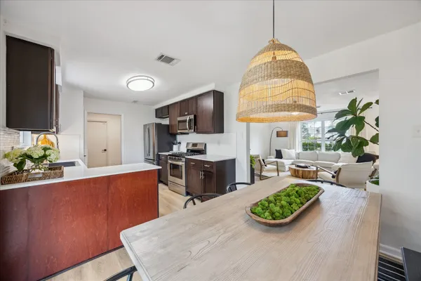a living room with furniture a flat screen tv and kitchen view