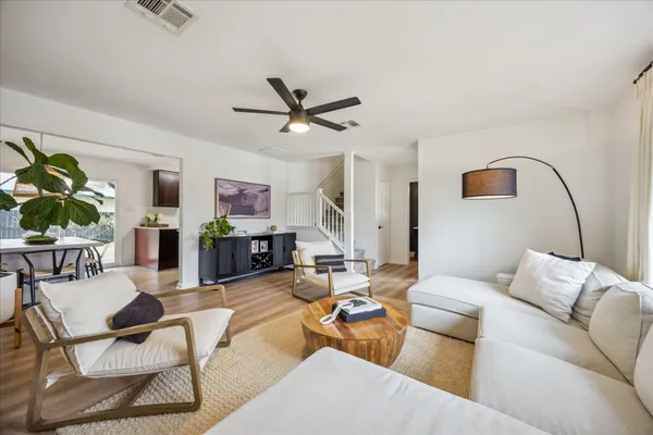 a living room with furniture and wooden floor