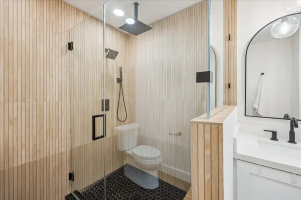 a bathroom with double vanity sinks and a mirror