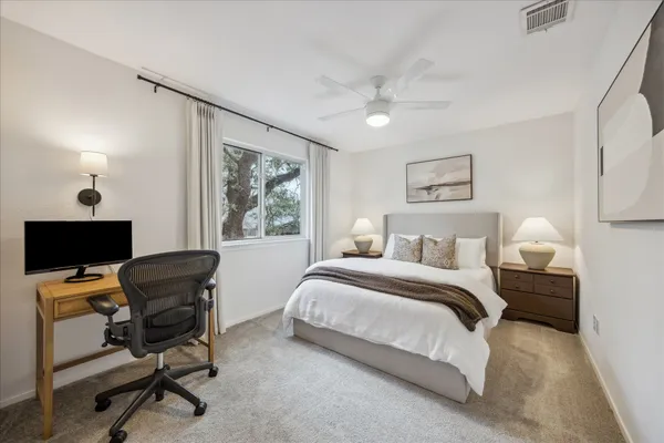 a bedroom with a bed and a large window with outer view