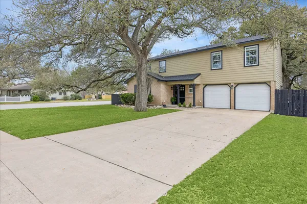 a front view of house with yard and green space