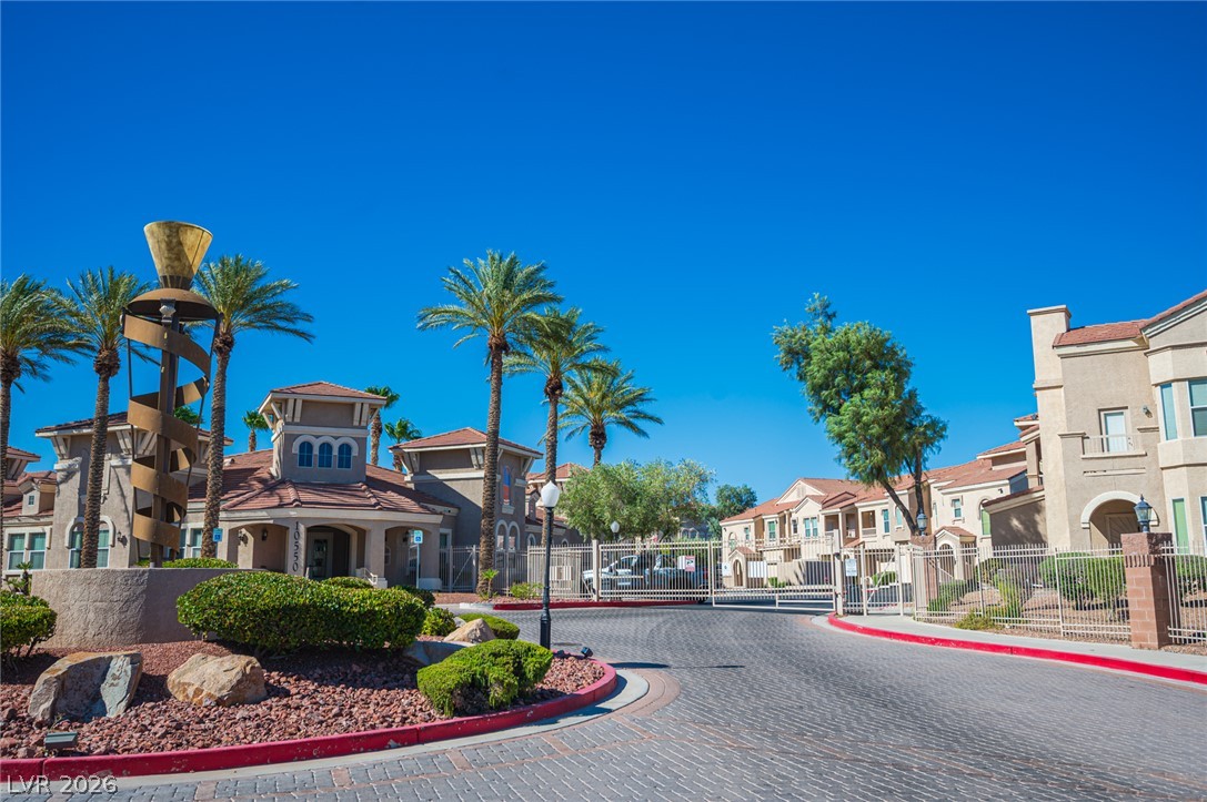 10550 West Alexander Road, Unit 2014 Las Vegas, NV 89129 - Photo 42 of 43 Secure gated access entry welcomes residents home along a neatly paved brick driveway.