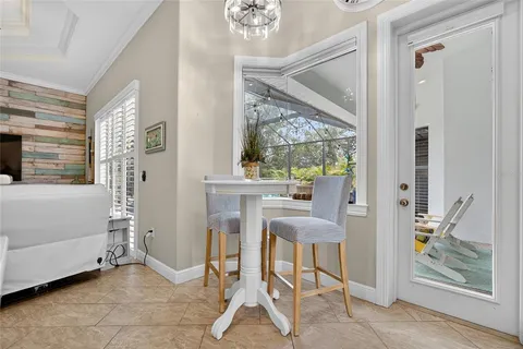 a view of a room with a table and chairs