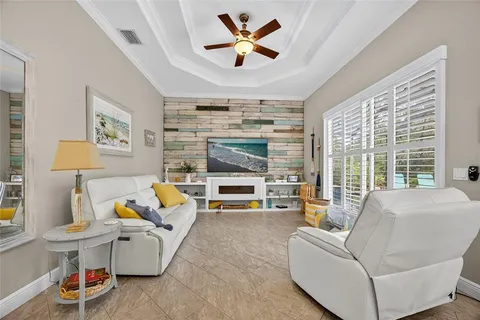 a living room with furniture fireplace and a large window