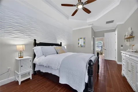 a bedroom with bed and wooden floor