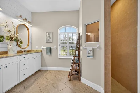 a spacious bathroom with a mirror a sink and a mirror