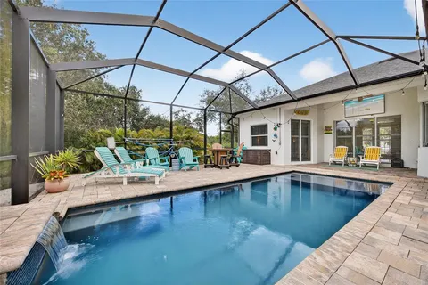 a view of swimming pool with outdoor seating