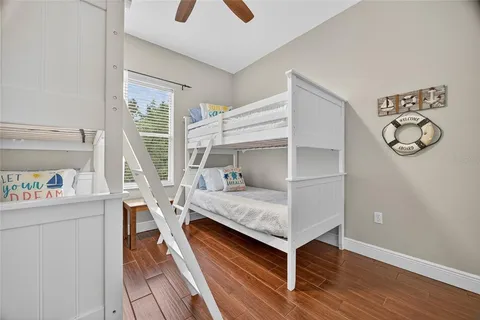 a bedroom with bunk bed and a window