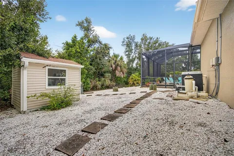 a backyard of a house with table and chairs