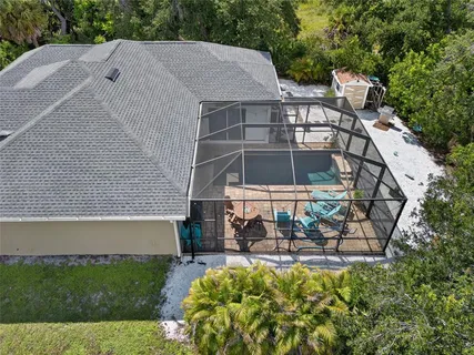 a aerial view of a house with swimming pool and garden