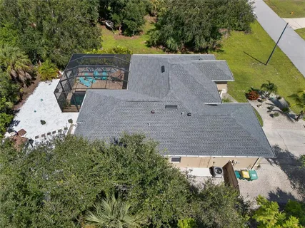 an aerial view of a house with yard