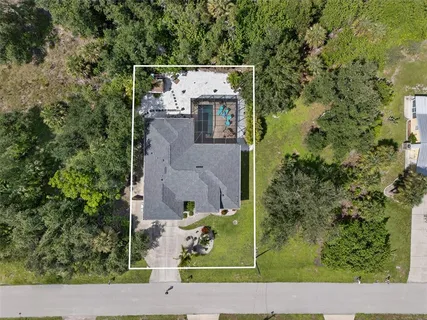 an aerial view of a house with a yard