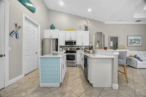 a kitchen with stainless steel appliances kitchen island wooden cabinets and center island