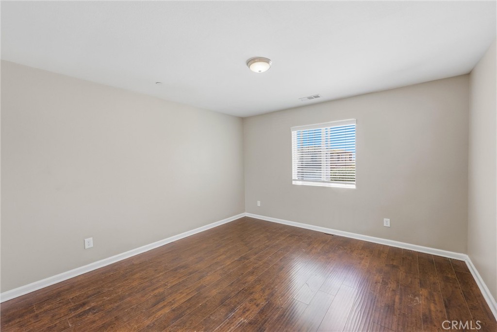 956 West Tibbot Street Rialto, CA 92377 - Photo 34 of 37 a view of a big room with wooden floor and windows in a room