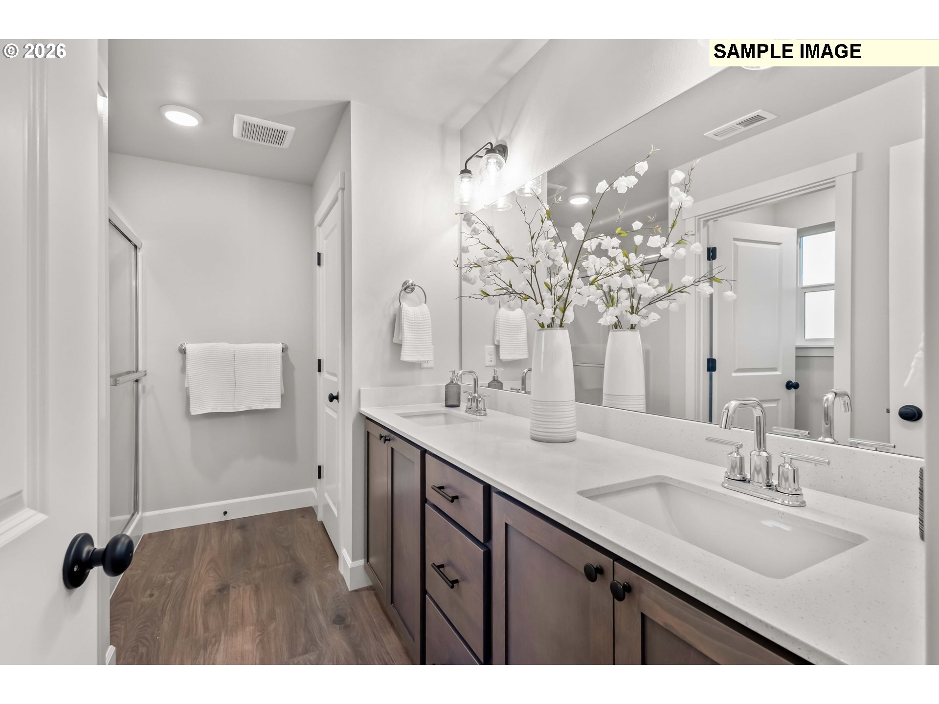 481 Taft Street Umatilla, OR 97882 - Photo 15 of 18 a bathroom with a double vanity sink a mirror and shower