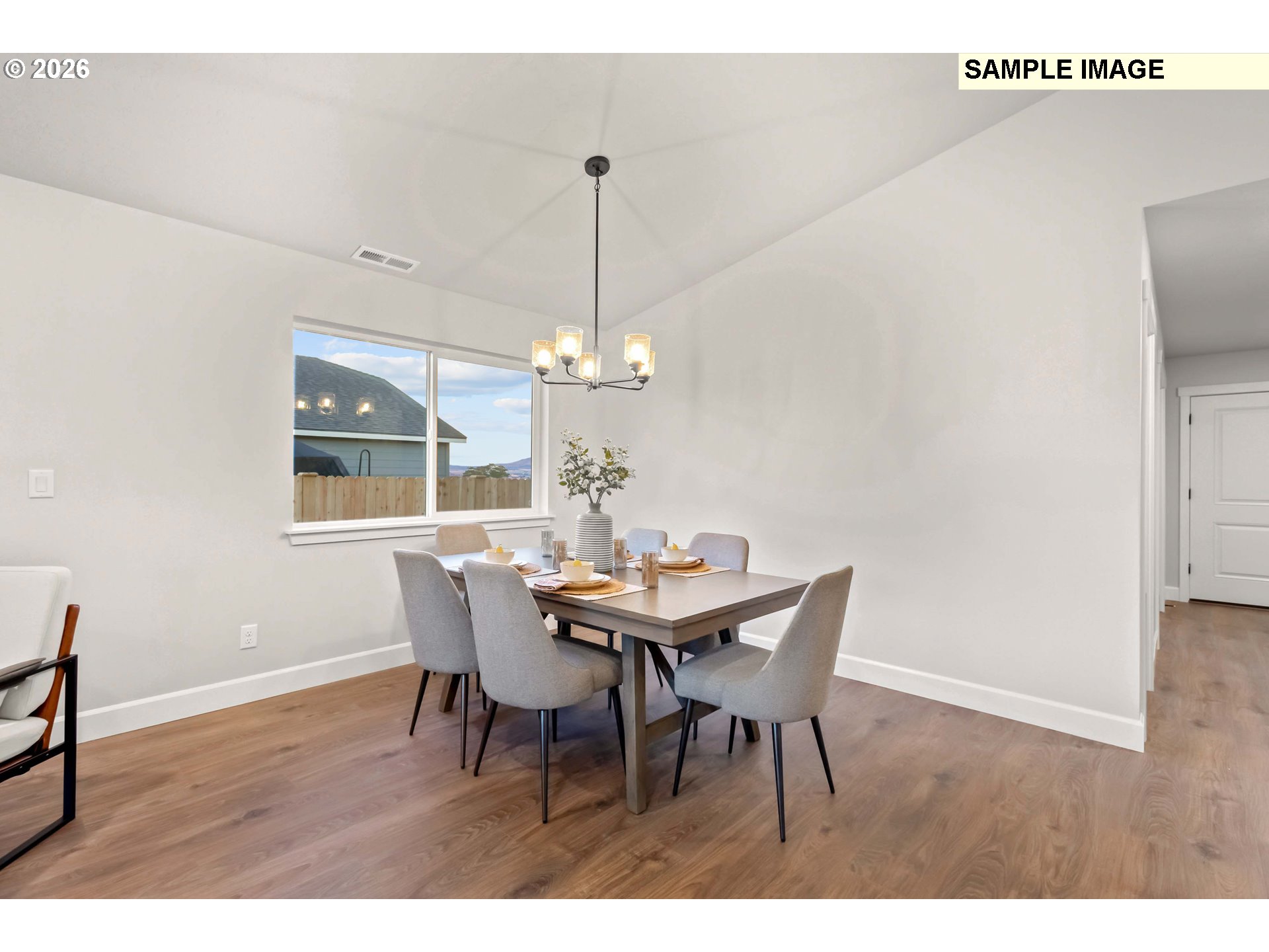481 Taft Street Umatilla, OR 97882 - Photo 6 of 18 a dining room with furniture a chandelier and wooden floor