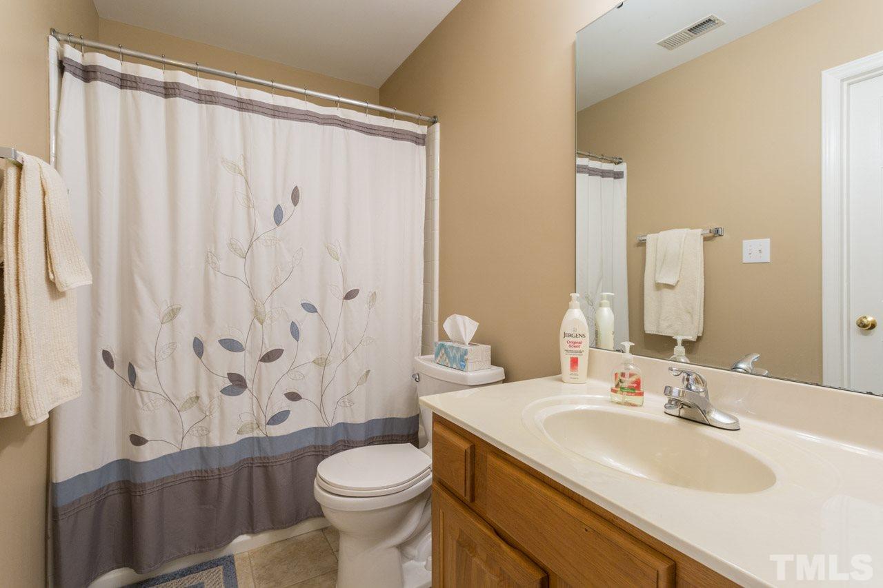 6705 Twin Tree Court Raleigh, NC 27613 - Photo 10 of 20 First floor bathroom - connects to family room and to first floor bedroom.