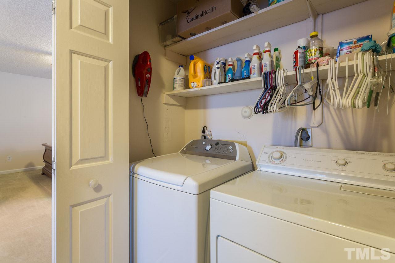 6705 Twin Tree Court Raleigh, NC 27613 - Photo 16 of 20 Utility room on the second floor with great shelving for organization.