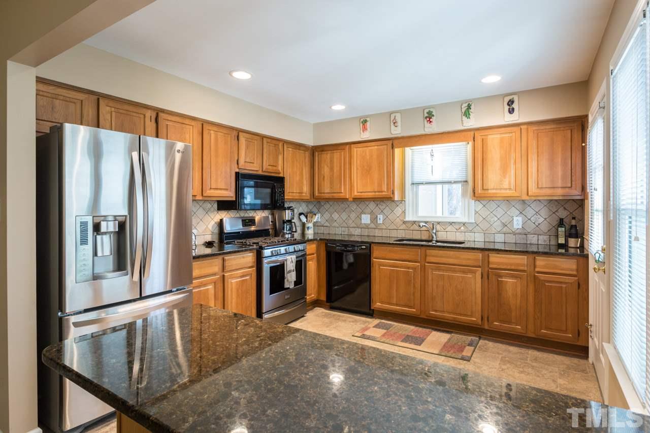 6705 Twin Tree Court Raleigh, NC 27613 - Photo 5 of 20 Open kitchen and bar seating area.