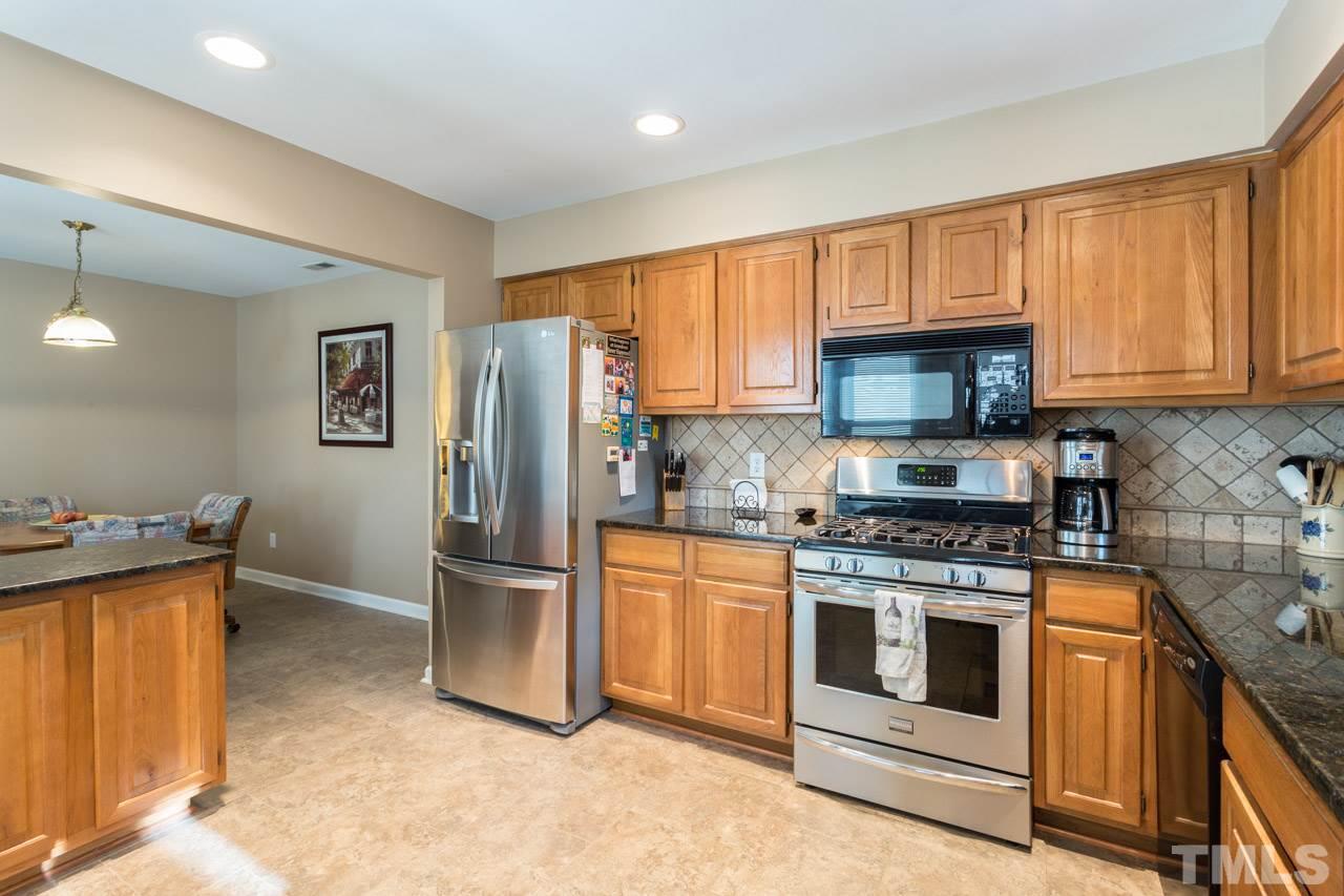 6705 Twin Tree Court Raleigh, NC 27613 - Photo 6 of 20 Great updated kitchen with gas cooktop, tile back splash and granite counters!