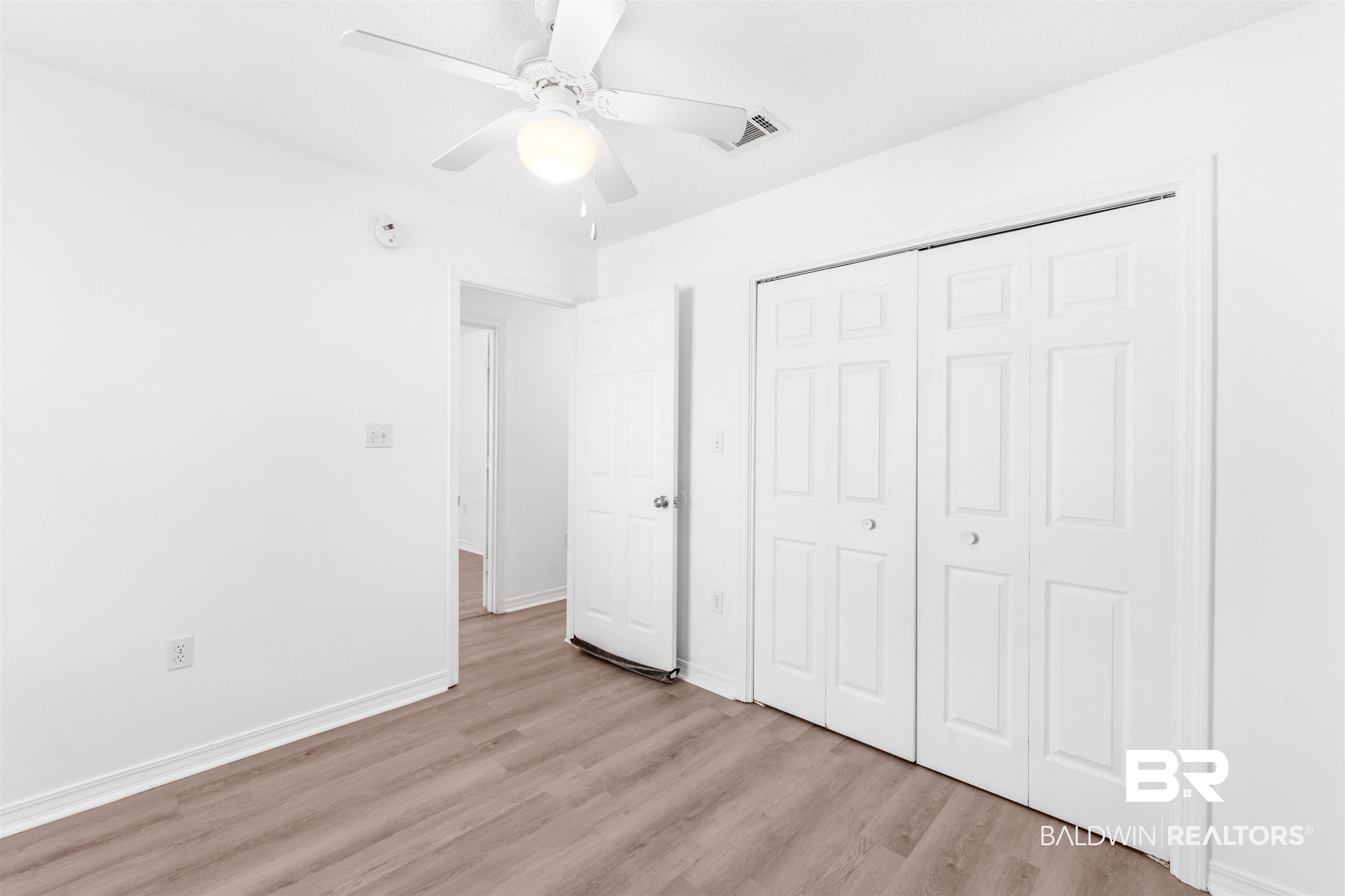 14919 Daugherty Road Foley, AL 36535 - Photo 23 of 27 Unfurnished bedroom featuring a closet, ceiling fan, and light hardwood / wood-style floors