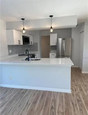 a view of living room with wooden floor and flat screen tv