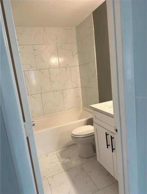 7149 Carmel Avenue New Port Richey, FL 34655 - Photo 6 of 13 a bathroom with a toilet and shower