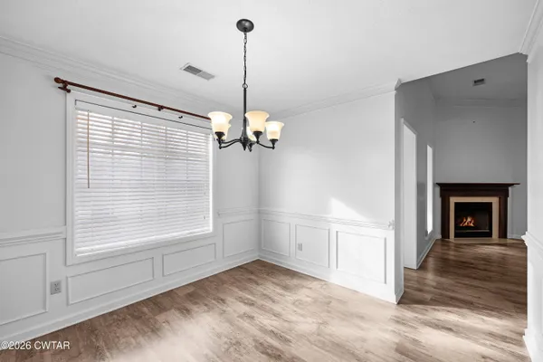 a view of empty room with window and fireplace