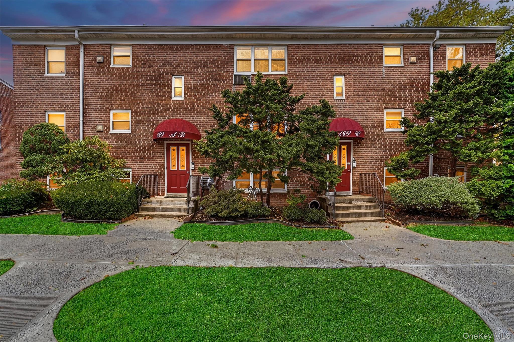 a front view of a house with a yard and a garage