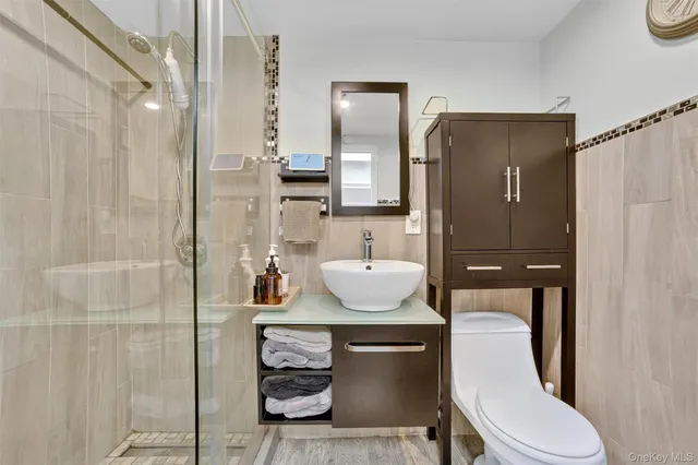 a bathroom with a toilet a sink and shower