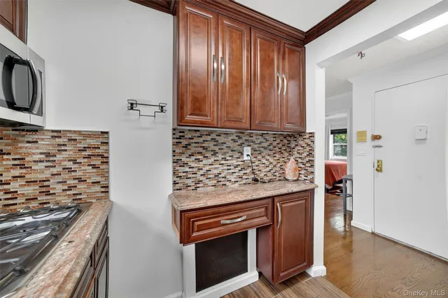 a kitchen with granite countertop a stove and a sink