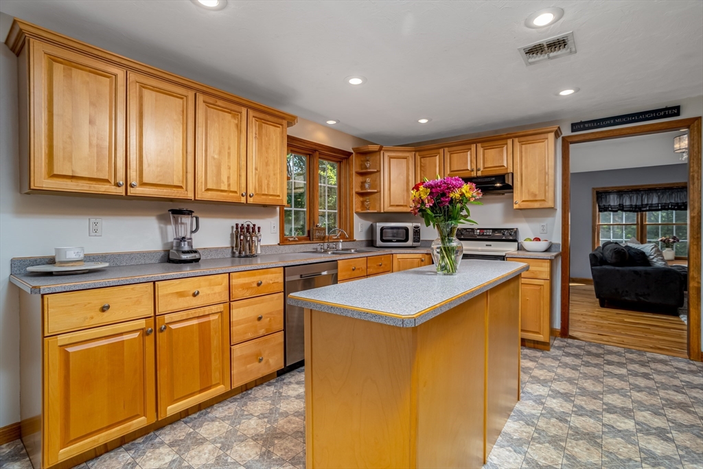 16 Hillside Drive Townsend, MA 01469 - Photo 3 of 35 a kitchen with stainless steel appliances granite countertop a sink counter space cabinets and a large window