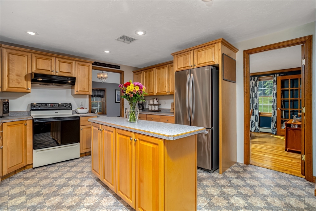 16 Hillside Drive Townsend, MA 01469 - Photo 4 of 35 a kitchen with stainless steel appliances granite countertop a refrigerator and a stove top oven