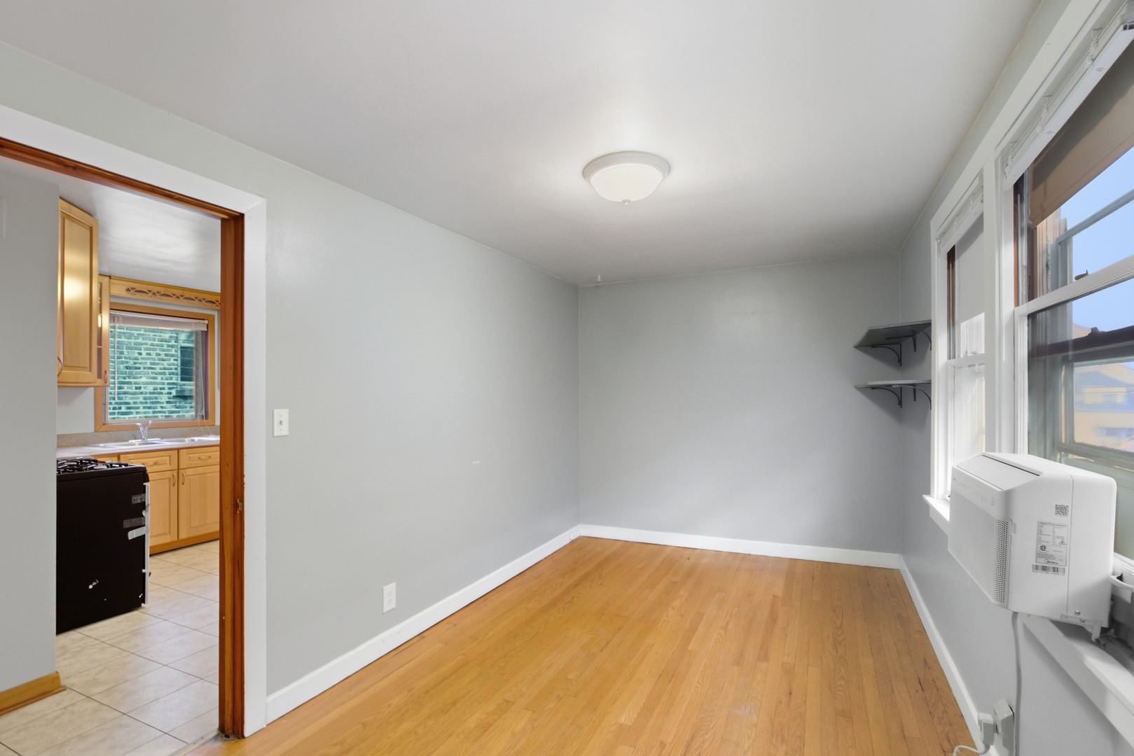5434 West Wrightwood Avenue Chicago, IL 60639 - Photo 11 of 21 a view of empty room with wooden floor and fan