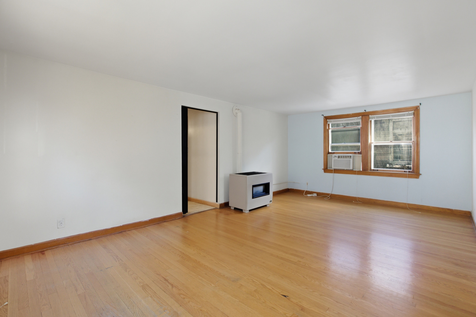 5434 West Wrightwood Avenue Chicago, IL 60639 - Photo 12 of 21 an empty room with wooden floor and windows
