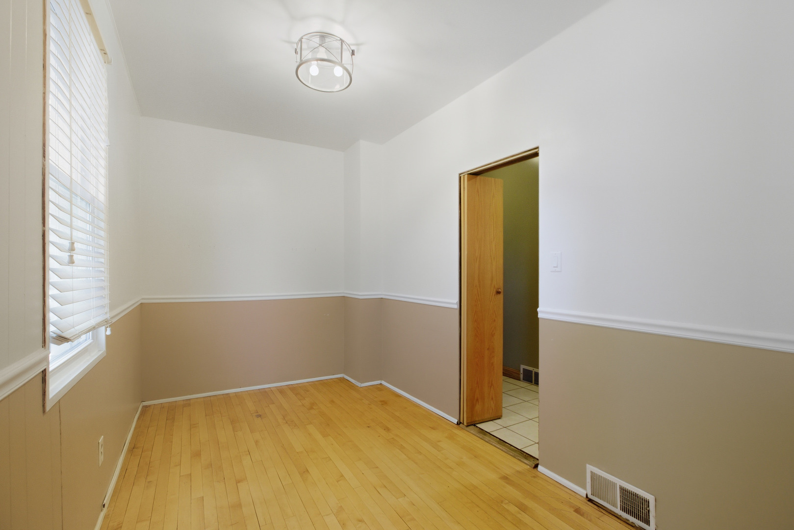 5434 West Wrightwood Avenue Chicago, IL 60639 - Photo 7 of 21 an empty room with a wooden floor