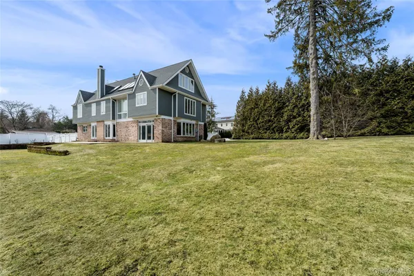 a big house with a big yard and large trees